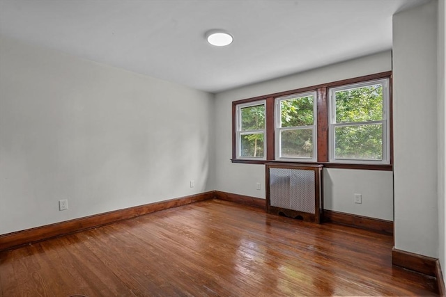 spare room with wood finished floors and baseboards