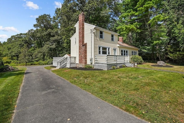 view of front of home with a front lawn and a chimney