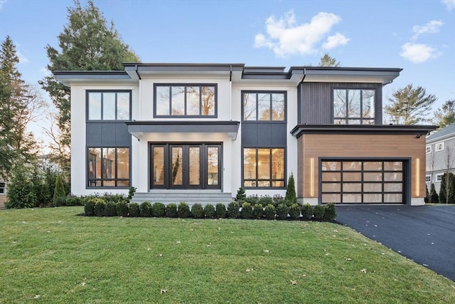 view of front of home featuring a garage and a front lawn