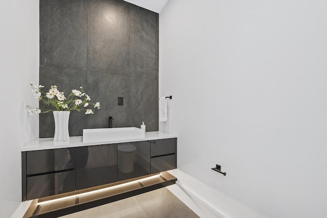 bathroom with sink, tile walls, and tile patterned flooring