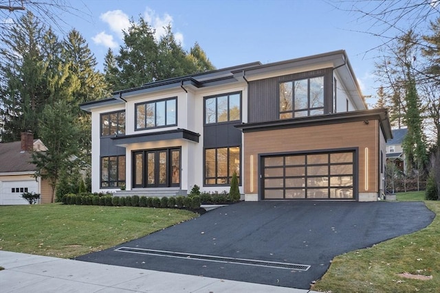 modern home with a garage and a front lawn