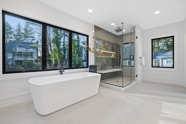 bathroom featuring tile patterned flooring and separate shower and tub