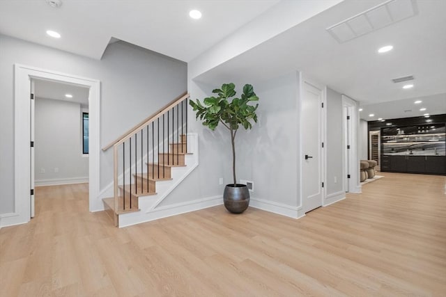 staircase featuring wood-type flooring