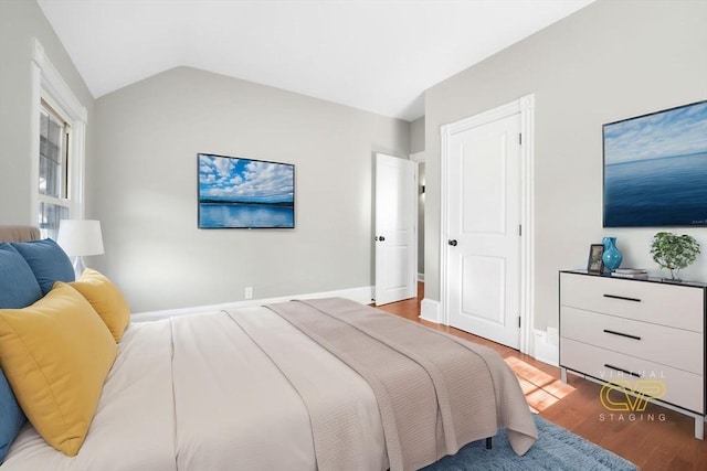 bedroom featuring vaulted ceiling and hardwood / wood-style floors