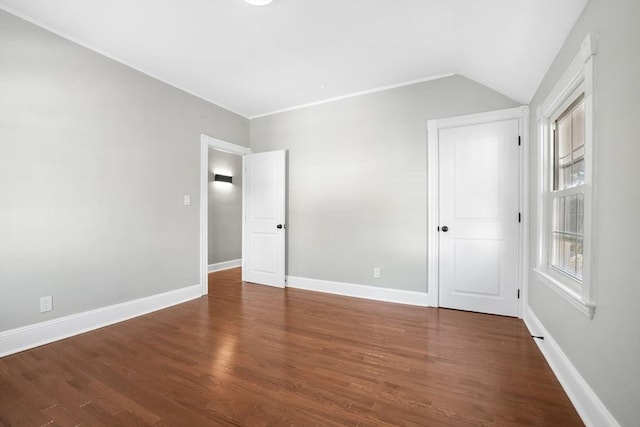 unfurnished room with dark hardwood / wood-style flooring and lofted ceiling