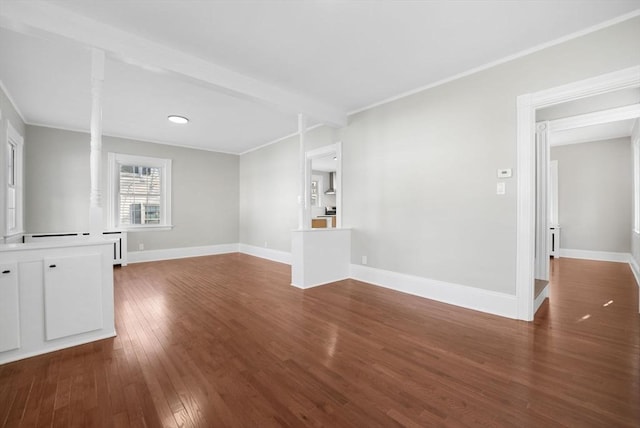 unfurnished living room with dark hardwood / wood-style flooring, ornamental molding, decorative columns, and beamed ceiling