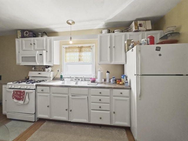 16 Willoughby St, Lawrence, MA 01841 - kitchen with white appliances, a sink, and white cabinetry