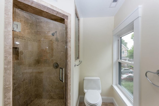 bathroom with walk in shower and toilet