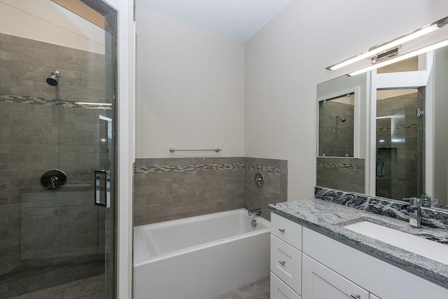 bathroom featuring vanity and independent shower and bath