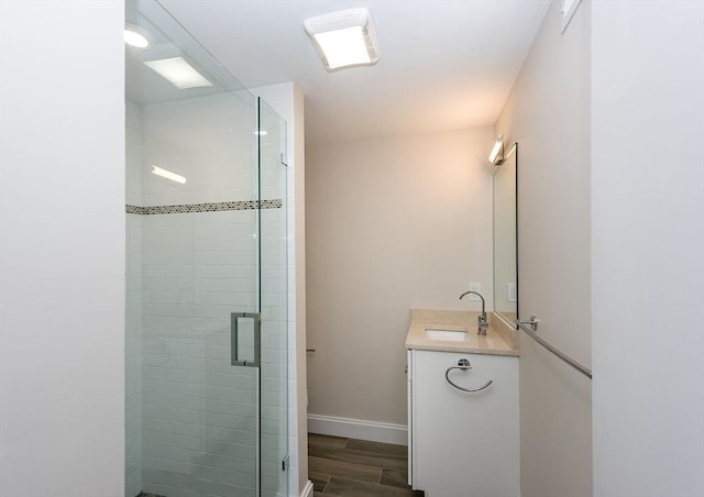 bathroom with vanity and a shower with shower door