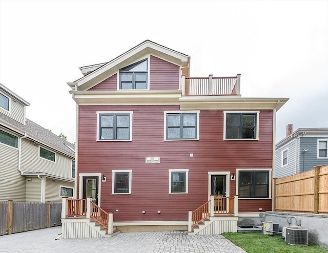 rear view of house featuring cooling unit and a patio