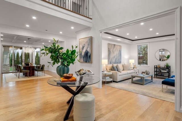 living room featuring beam ceiling, light wood-type flooring, and coffered ceiling