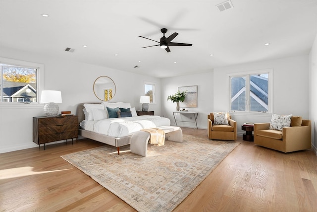 bedroom with ceiling fan and light hardwood / wood-style flooring