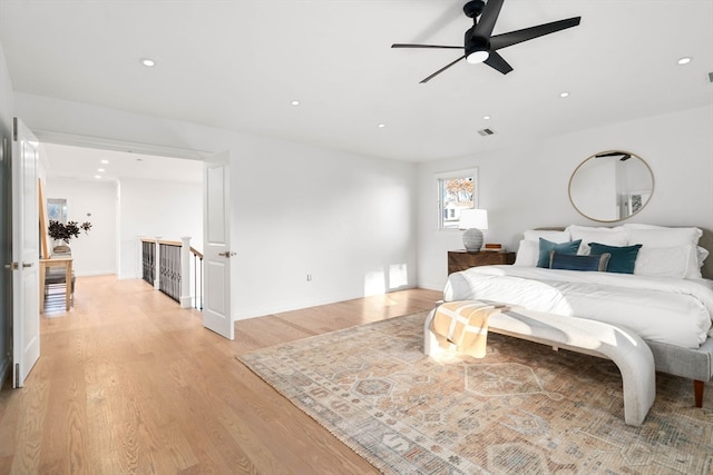 bedroom with light hardwood / wood-style floors and ceiling fan