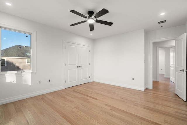 unfurnished bedroom with light wood-type flooring and ceiling fan