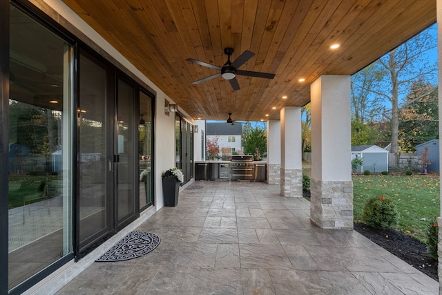 view of patio / terrace with a grill, a shed, area for grilling, and ceiling fan