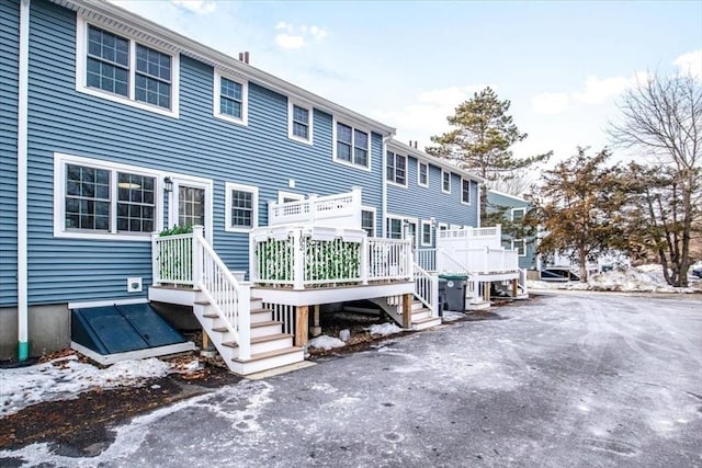 snow covered house with a deck