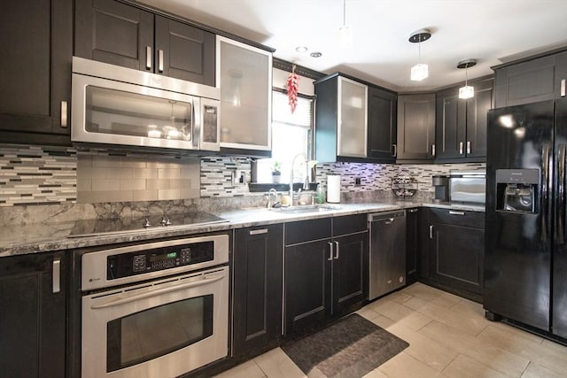 17 Lantern Rd, Revere, MA 02151 - kitchen with black appliances, a sink, tasteful backsplash, decorative light fixtures, and light tile patterned flooring