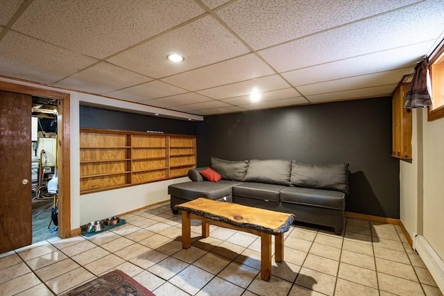 17 Lantern Rd, Revere, MA 02151 - living area featuring baseboard heating, a paneled ceiling, light tile patterned flooring, and baseboards