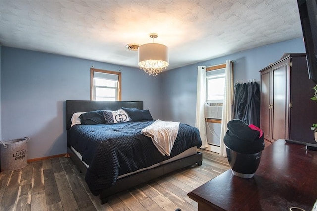 17 Lantern Rd, Revere, MA 02151 - bedroom with wood finished floors, a baseboard heating unit, a chandelier, and cooling unit
