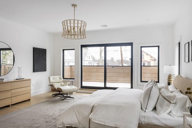 224 Auburn St Unit F, Newton, MA 02466 - bedroom featuring access to outside, wood finished floors, and a chandelier