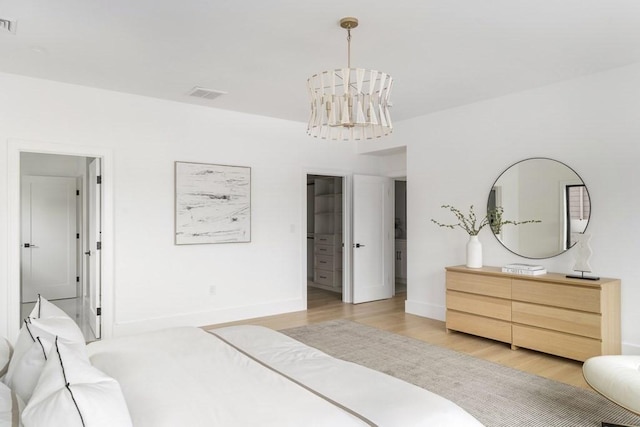 224 Auburn St Unit F, Newton, MA 02466 - bedroom with light wood-style floors and a chandelier