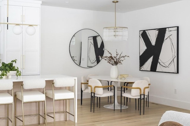 224 Auburn St Unit F, Newton, MA 02466 - dining space with light wood-type flooring and a chandelier