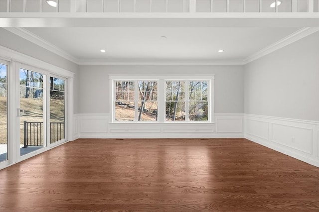 unfurnished room featuring ornamental molding, wainscoting, wood finished floors, and recessed lighting