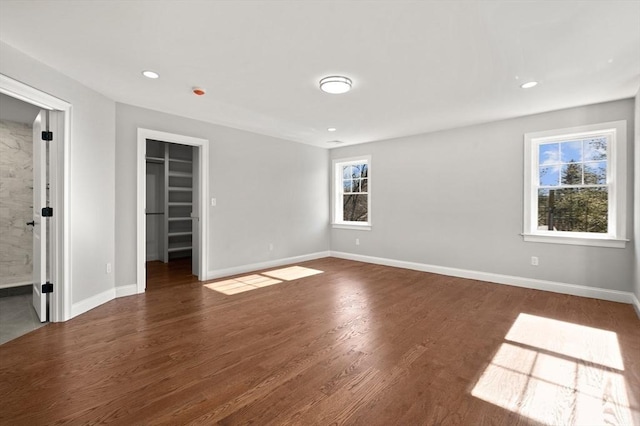 spare room with recessed lighting, baseboards, and wood finished floors