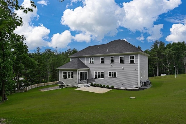 rear view of property featuring central air condition unit, a patio area, fence, and a lawn