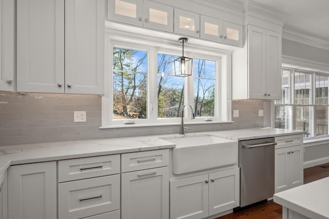 kitchen with decorative backsplash, stainless steel dishwasher, ornamental molding, white cabinetry, and a sink