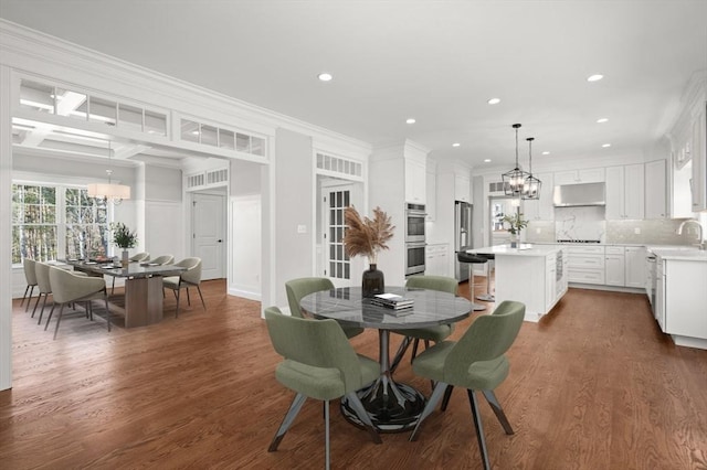 dining space with recessed lighting, a chandelier, dark wood-style flooring, and ornamental molding