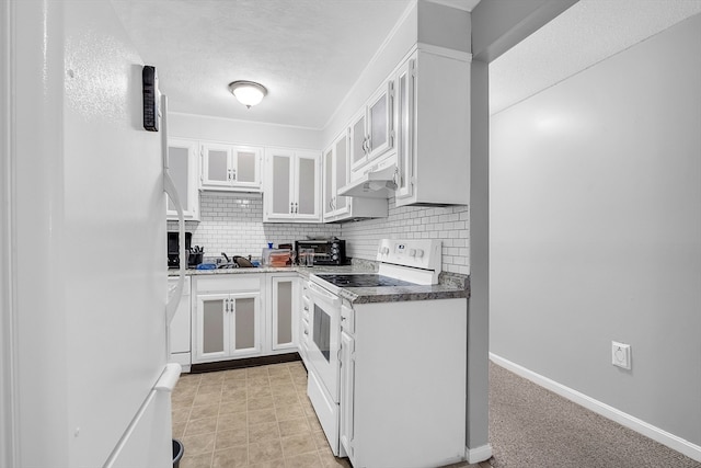 kitchen with backsplash, sink, white cabinets, white appliances, and light colored carpet