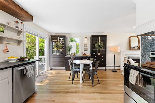 6 Manomet Rd, Woburn, MA 01801 - dining room with light wood-type flooring and a fireplace
