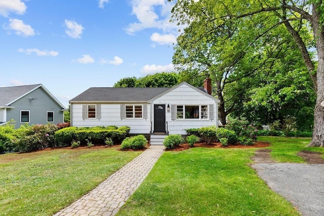 6 Manomet Rd, Woburn, MA 01801 - view of front of property with a chimney and a front yard