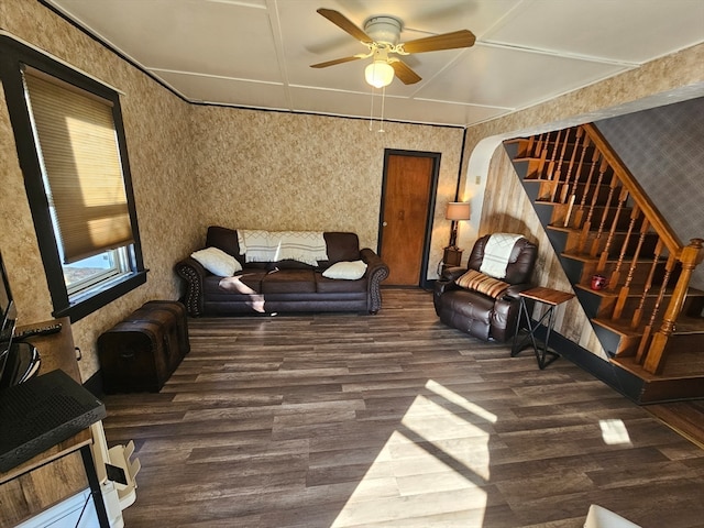 living room with dark hardwood / wood-style flooring and ceiling fan