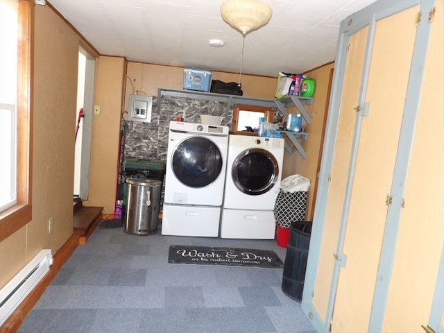 washroom with washing machine and clothes dryer and a baseboard heating unit