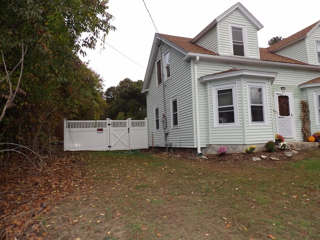 view of side of home featuring a yard