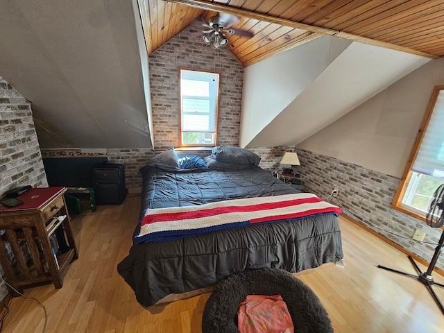 bedroom with vaulted ceiling, wooden ceiling, and brick wall