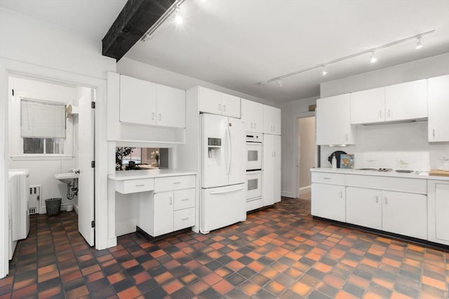 kitchen with radiator heating unit, white appliances, white cabinetry, and beamed ceiling