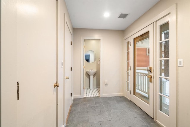 hallway featuring sink and french doors