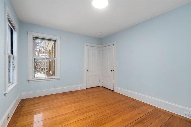 unfurnished room with light wood-type flooring