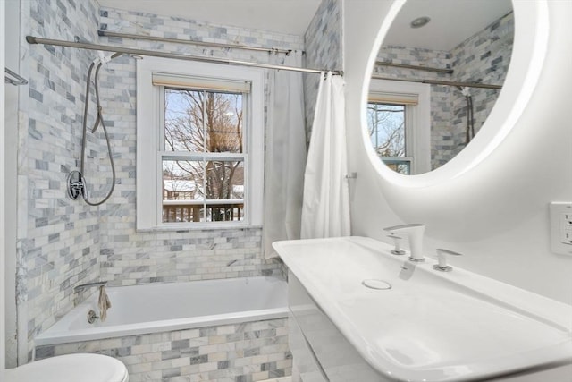 bathroom with toilet, shower / bath combination with curtain, and plenty of natural light