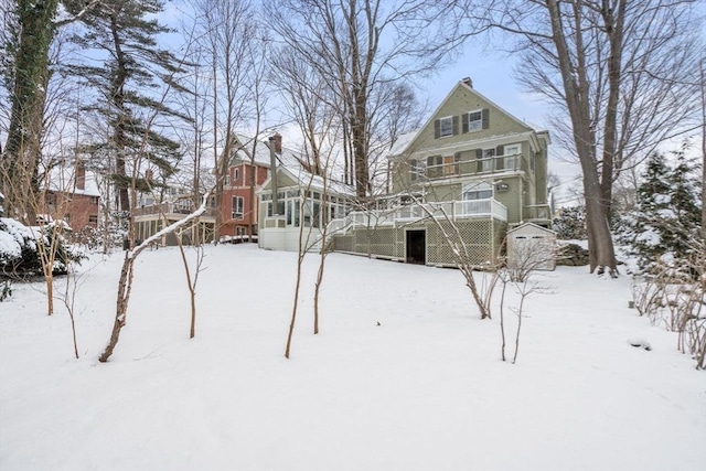 yard covered in snow featuring a deck