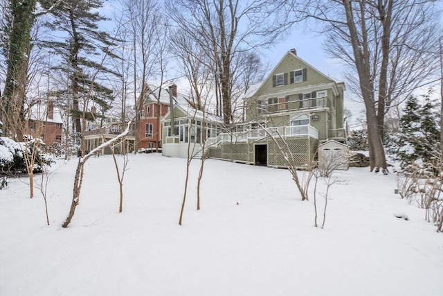 yard covered in snow featuring a wooden deck