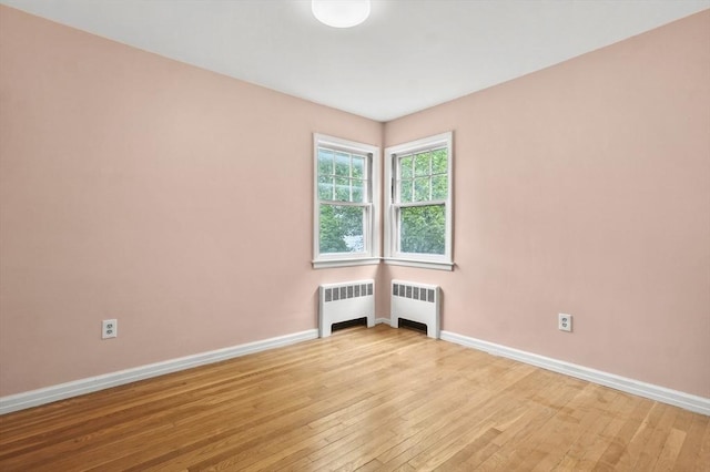 23 Ivan St, Lexington, MA 02420 - spare room with radiator and light wood-style floors