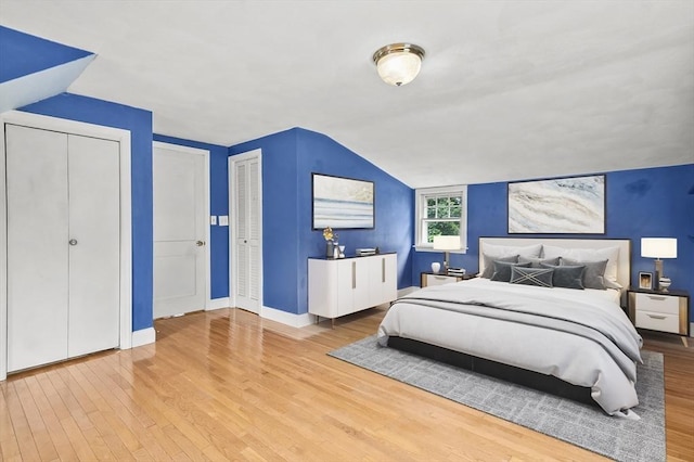 23 Ivan St, Lexington, MA 02420 - bedroom with wood finished floors, vaulted ceiling, and multiple closets