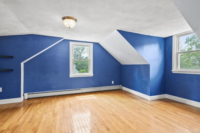 23 Ivan St, Lexington, MA 02420 - bonus room featuring baseboard heating, hardwood / wood-style flooring, and vaulted ceiling
