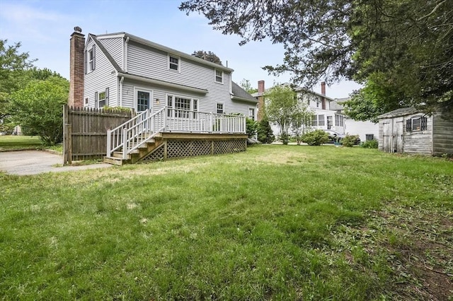 23 Ivan St, Lexington, MA 02420 - back of property with a chimney, a wooden deck, a yard, and a shed