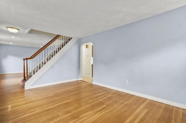 23 Ivan St, Lexington, MA 02420 - unfurnished living room featuring stairway, light wood-style floors, and arched walkways